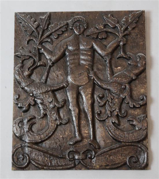 A 17th century carved oak portrait of a youth flanked by griffins, 14 x 12in.